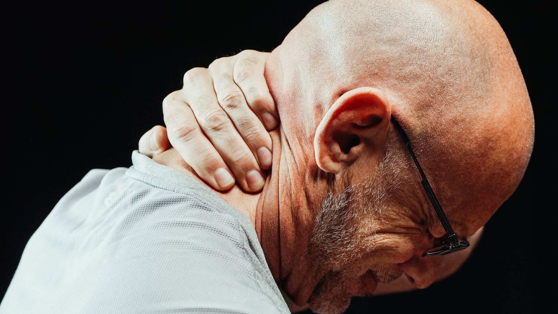 close up photo of a man having a neck pain